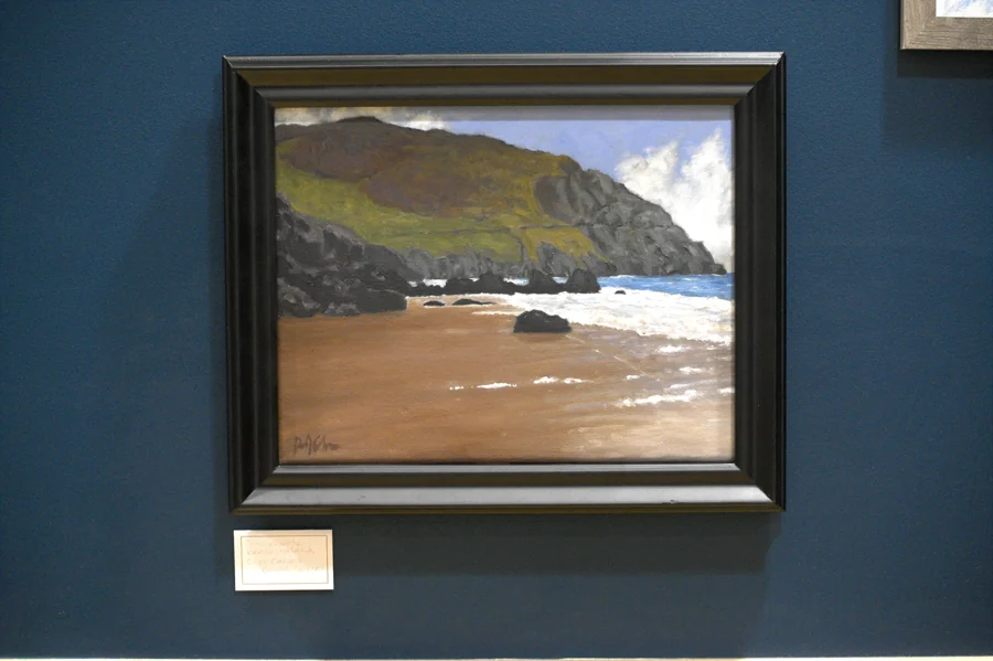 A rocky coastal landscape painted by Rachel Cochran