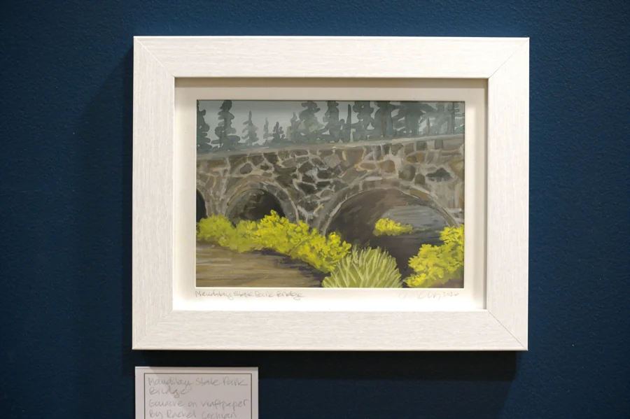 A stone bridge and flowers painted by Rachel Cochran