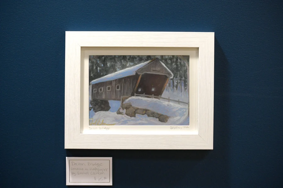 A snowy covered bridge painted by Rachel Cochran